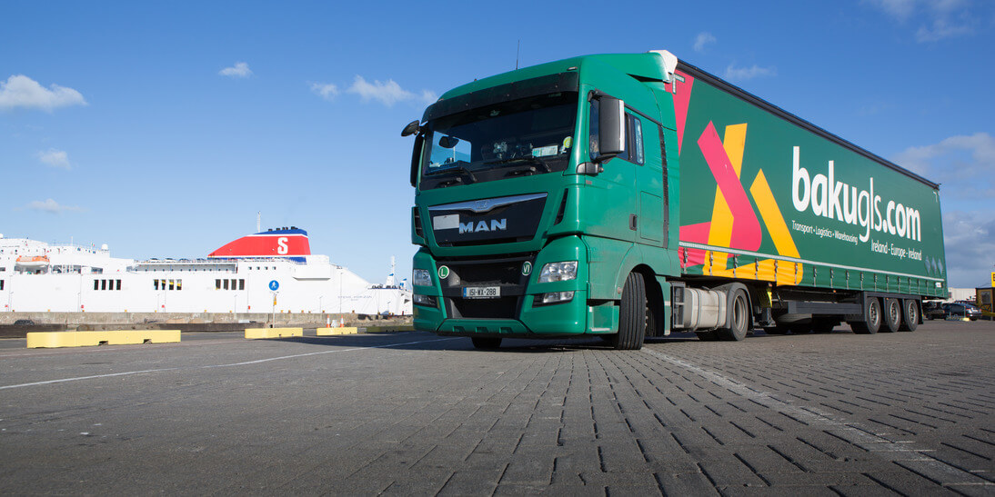 the front of bakguls.com lorry taken at a low angle with a ferry in the back ground