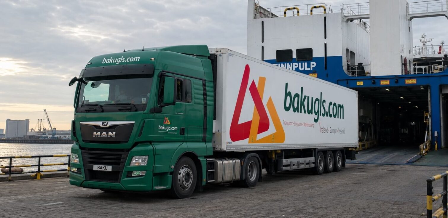 A bakugls.com lorry departing from a ferry. The front of the lorry is dark green while the back is white with the bakugls.com logo on it